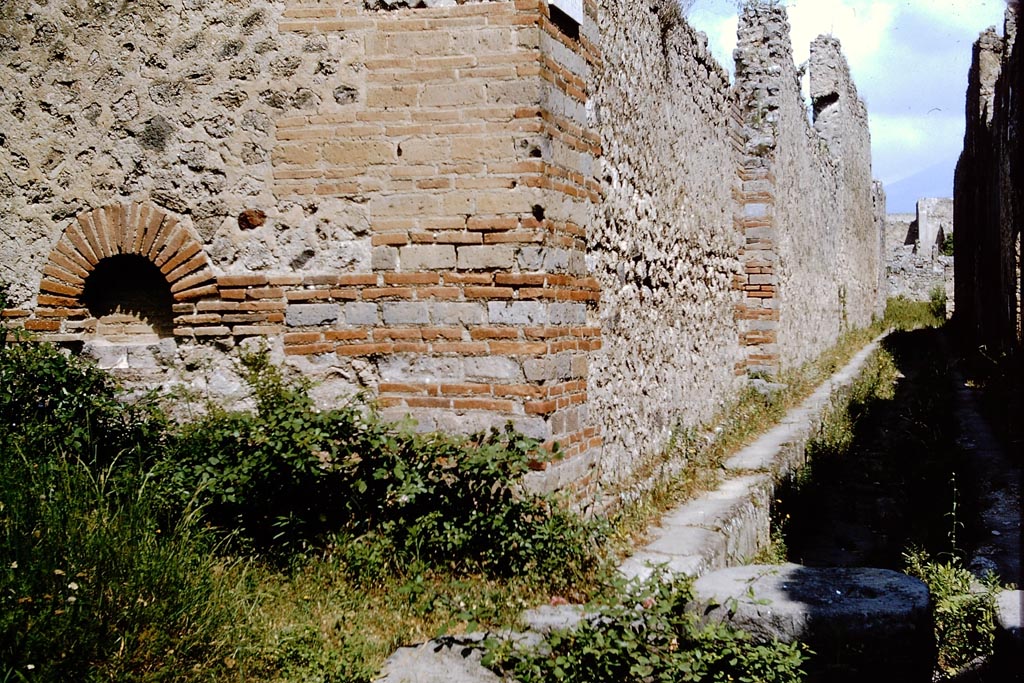 Street altar on south-east corner of IX.4, looking along Vicolo di Tesmo between IX.4 and IX.5, on the right. Pompeii. 1964. 
Looking north from junction with unnamed vicolo, on the left. Photo by Stanley A. Jashemski.
Source: The Wilhelmina and Stanley A. Jashemski archive in the University of Maryland Library, Special Collections (See collection page) and made available under the Creative Commons Attribution-Non-Commercial License v.4. See Licence and use details.
J64f1610
