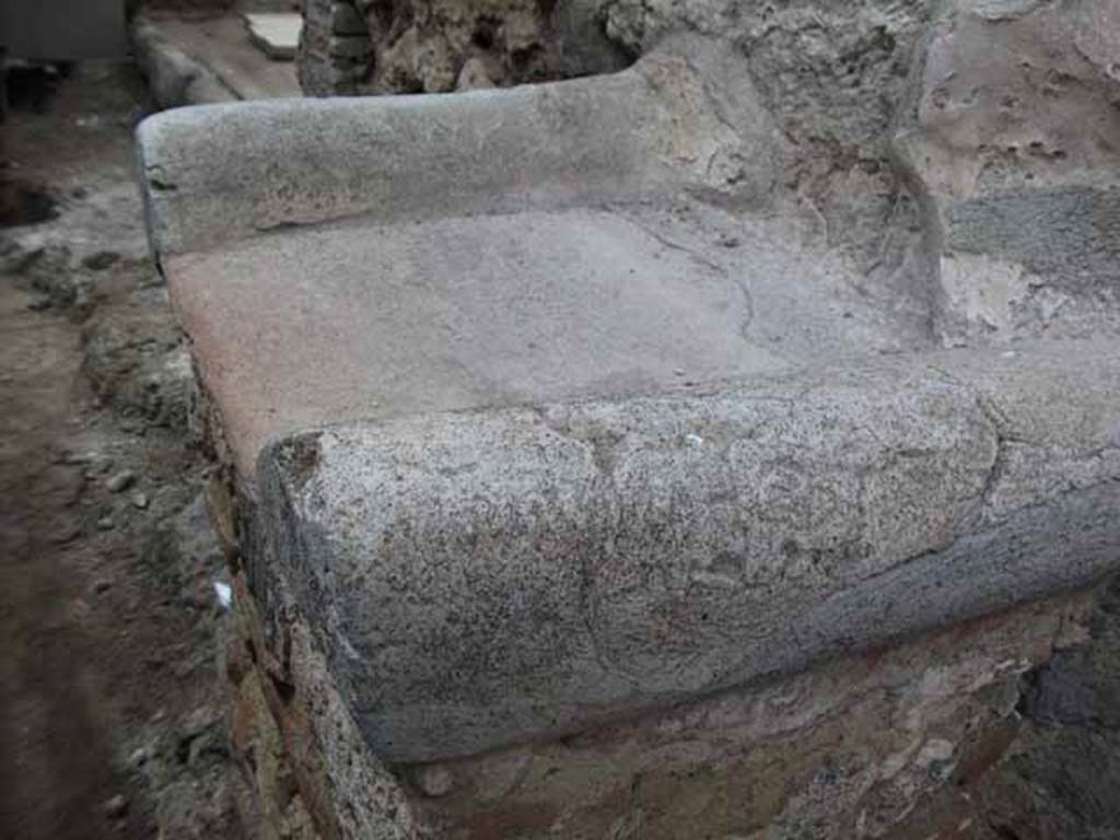 Street altar outside IX.12.7. May 2010. Top of street altar. When excavated the remains of carbon and ash from an offering were found on the altar. See Della Corte, M., 1965. Case ed Abitanti di Pompei. Napoli: Fausto Fiorentino. (660-661; p. 323).