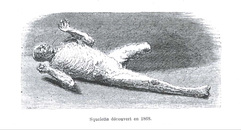 Victim number 5, (After Ernest Breton, Pompeia, 3rd ed. (1869) p. 272.) Photo courtesy of Eugene Dwyer.
Plaster-cast of victim numbered 5, 1868, and on display in one of the rooms of the Archaeological School (VI.17.27).
According to Breton –
“This unfortunate was discovered lying on his stomach in a room to the left of the atrium in the House of Gavius Rufus (VII.2.16).
Six other skeletons were near him.
This cast came out best of all, with the exception of the left leg, which could not be reproduced, and further that his expression is the most terrifying.
He is the embodiment of despair, driven to his final paroxysm.”
See Breton, Ernest. 1870. Pompeia, Guide de visite a Pompei, 3rd ed. Paris, Guerin., (p.272-73).
