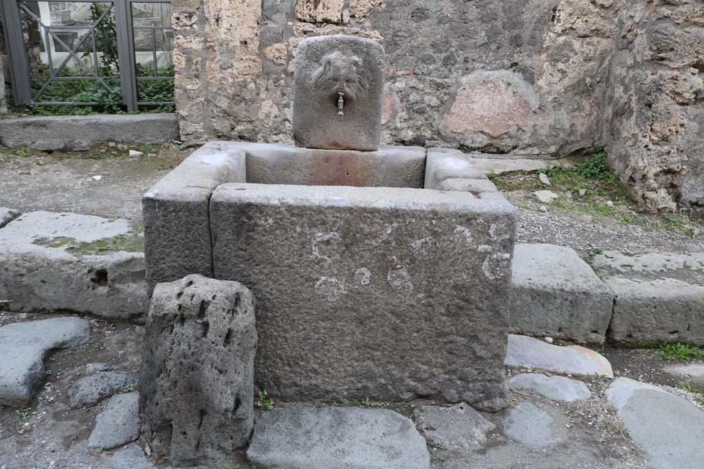 Fountain outside VI.16.28 on Vicolo dei Vettii. December 2018. Looking east. Photo courtesy of Aude Durand.