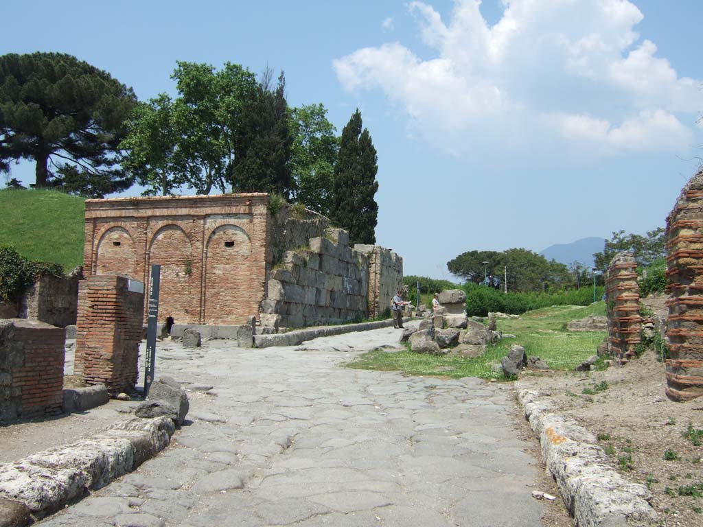 Castellum Aquae Pompeii. May 2006. Looking north from Via del Vesuvio.
Initially most people used wells or collected rainwater in the impluvium of their houses and water supply was not always reliable.  
The construction of an aqueduct by Augustus solved this problem, bringing water from Serino in Avellino province.
A branch of the Serino aqueduct brought water to Pompeii.
A water tower or castellum Aquae was built at the highest point in the town next to the Vesuvian Gate.
It was at about 43 metres above sea level in order to make the distribution easier. 
It fed a series of water columns with tanks on top which helped maintain pressure and regulate flow.
