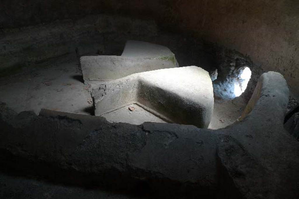 Castellum Aquae Pompeii. July 2010. Basin “B” inside water tower. 
Wall b is at the front, and in the basin are directing walls “G” with dividing walls “m” and “m’ “ at their rear.
The three water outlets could be regulated by a means of shutters which could stop the flow of water if lowered. 
Lead pipes or fistulae fed water to the public fountains and the public baths and to the houses of wealthy citizens.
Some houses had their own suite of baths or large fountains and fountain ornaments in their gardens. 
