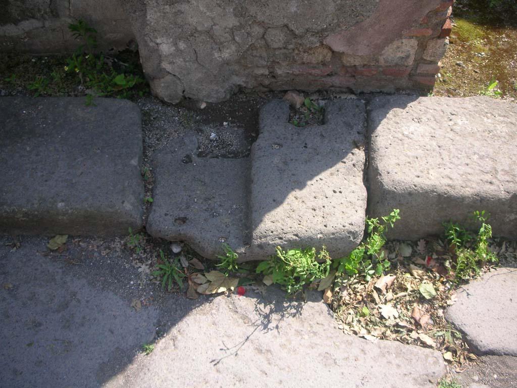 Porta Ercolano or Herculaneum Gate, Pompeii. May 2010. 
Roadway through gate, detail from west side of gate at south end, area of “double-leaf gate”. Photo courtesy of Ivo van der Graaff.
According to Van der Graaff –
“The gate features a large central roadway open to cart traffic with two smaller flanking pedestrian passageways on either side.
Barrel vaults covered the side passages, whereas the central bay was open to the sky. 
A portcullis on the exterior and a double leaf gate on the interior closed the passageway on either end. The result was a typical open court plan ………… 
Open court gates had a clear military function to trap attackers and allow defenders to bombard them from an elevated position……………
It never achieved full military functionality since the current remains do not indicate an easy access to the second floor. 
Instead, the gate is almost exclusively a monumental structure that resembles a triumphal arch.”
See Van der Graaff, I. (2018). The Fortifications of Pompeii and Ancient Italy. Routledge, (p.129).
