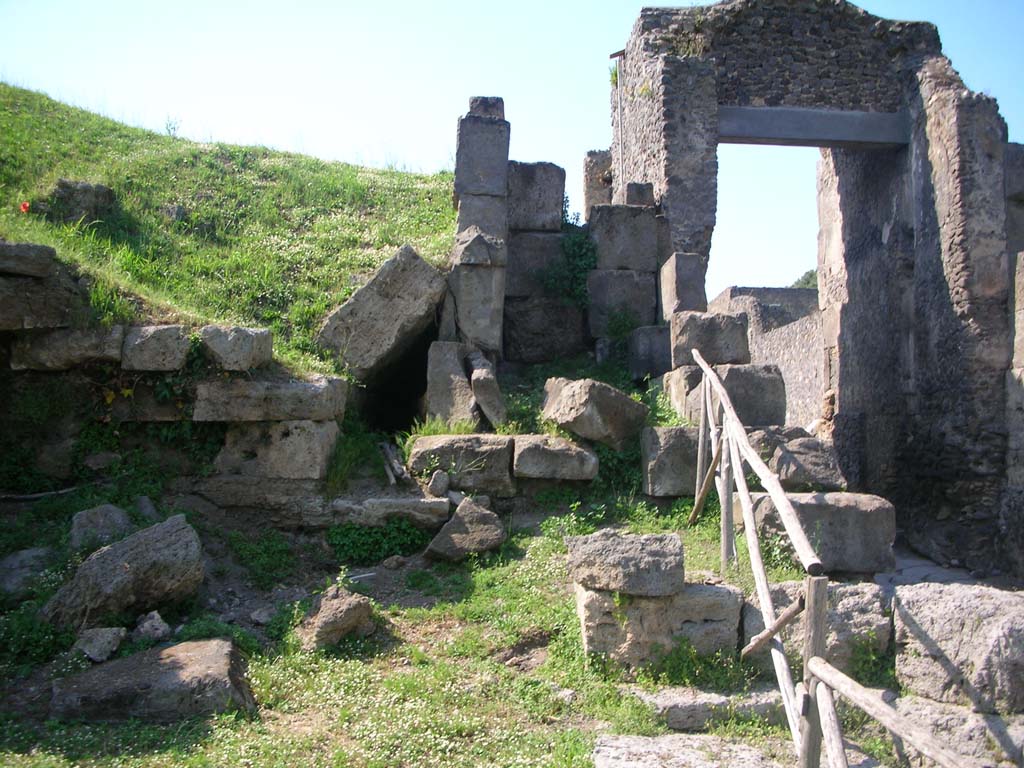 Porta di Nocera or Nuceria Gate, Pompeii. May 2010. 
Looking north on west side of gate, towards site of outlet of drain, centre left. Photo courtesy of Ivo van der Graaff.
