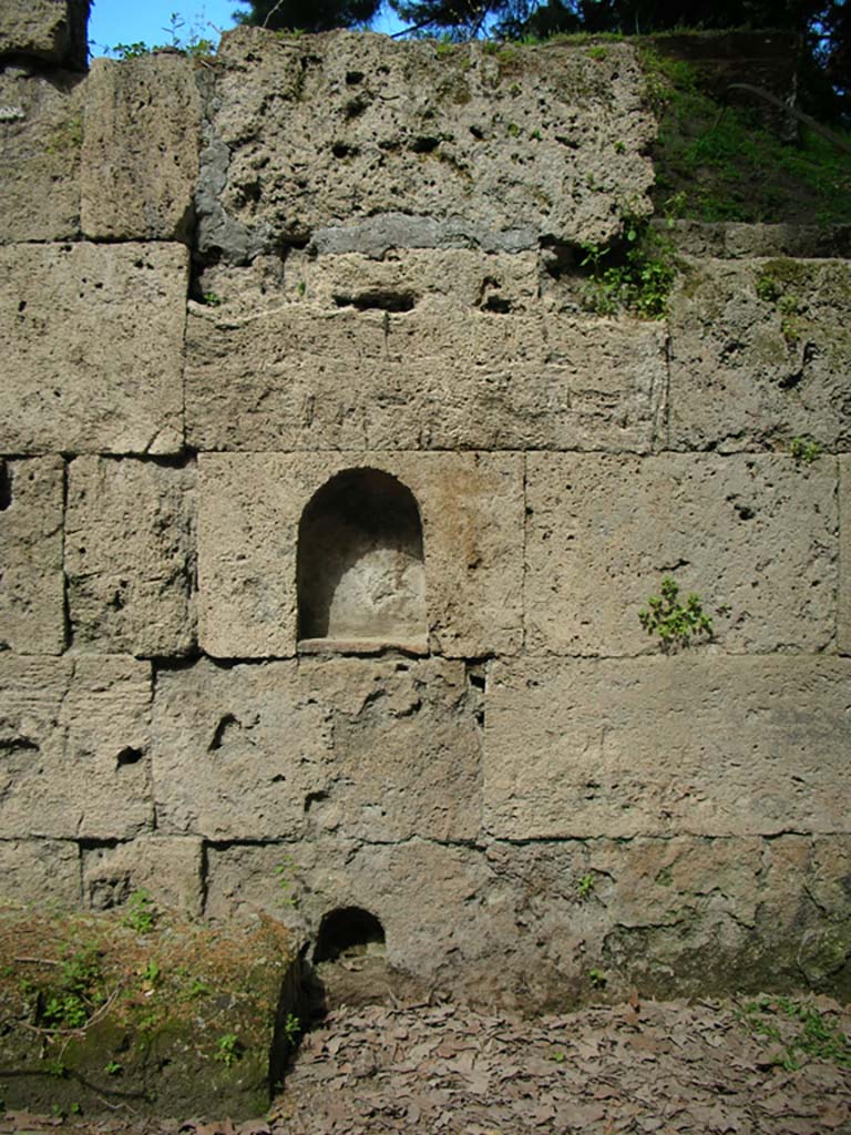 Porta Stabia, Pompeii. May 2010. East wall. Photo courtesy of Ivo van der Graaff.
According to Van der Graaff –
“The partial burial of the altar in the late second century BCE included a ritual deposition placed along its south side.
Among the votive deposits were small votive cups, burnt remains of a sheep/goat vertebra and a pig mandible, and three broken parts of a small terracotta figure (See Fig. 8.3).   ………………….
The lack of defining attributes makes any further identification difficult, but her frontal pose is strikingly similar to a statue of Minerva recovered at the Porta Marina, as well as votive figurines related to a regional cult (Note 13).
See Van der Graaff, I. (2018). The Fortifications of Pompeii and Ancient Italy. Routledge, (p.207).



