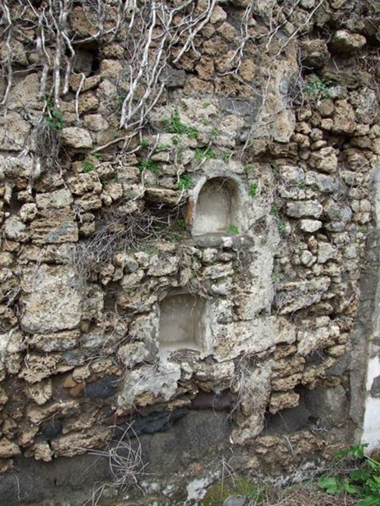 VII.11.14 Pompeii. March 2009. Garden “C”, two small niches on west wall at the north end. According to Boyce, in the same wall to the right of the lararium were set two smaller arched niches. He could not prove whether one or both of these niches had served as a shrine. He thought it was possible that they may have originally been built as lararia and then later been replaced by the large one, described above.
See Boyce G. K., 1937. Corpus of the Lararia of Pompeii. Rome: MAAR 14. (p.70, no.311) 
