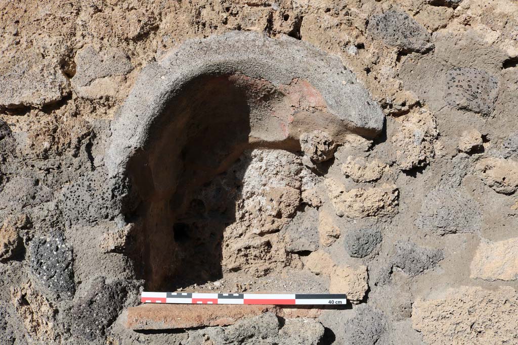 IX.2.11 Pompeii. December 2018. Detail of niche on north wall at west end. Photo courtesy of Aude Durand.
According to Boyce, this arched niche (h.0.45, w.0.38, d.0.25, h. above floor 1.30) was painted red on the inside and may have been a Lararium.
See Boyce G. K., 1937. Corpus of the Lararia of Pompeii. Rome: MAAR 14. (p.80-81, no.393). 
