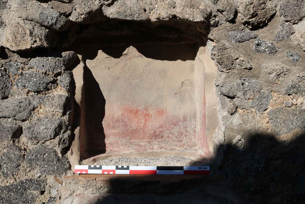 IX.2.12 Pompeii. December 2018. Detail of niche in north wall. Photo courtesy of Aude Durand.
According to Boyce, this square niche (0.50 square, d.0.24, h. above floor 1.25) was painted red on the inside, the same as the one found in IX.2.11.
He said that one or both of them may have been lararia.
See Boyce G. K., 1937. Corpus of the Lararia of Pompeii. Rome: MAAR 14. (p.80-81, no.393). 
