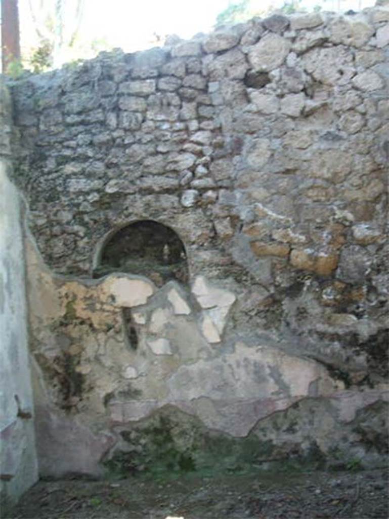 IX.7.20 Pompeii. May 2005. Niche in kitchen, room (p).
According to Boyce, in the west wall of the kitchen, in the south-west corner of the house, was once a niche.
This niche was coated with white stucco but was subsequently bricked-up.
See Boyce G. K., 1937. Corpus of the Lararia of Pompeii. Rome: MAAR 14. (p.88, no.440) 
See Giacobello, F., 2008. Larari Pompeiani: Iconografia e culto dei Lari in ambito domestico. Milano: LED Edizioni. (p.210, no.107)

