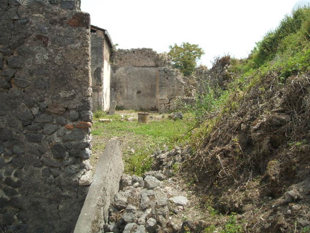 IX.8.c Pompeii. February 2020. 
Looking from rooms on north side across peristyle towards a room on south side, and into the unexcavated. Photo courtesy of Aude Durand.
