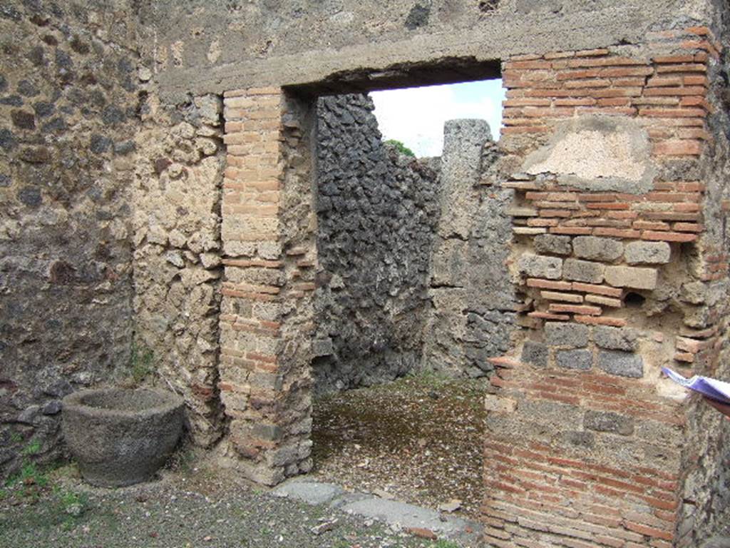 IX.9.6 Pompeii. May 2006. Niche in west wall of cubiculum.
According to Boyce – 
this niche (h.0.45, w.0.41, d.0.18, h. above floor 1.27) had walls coated with white stucco decorated with green, yellow and violet spots, probably representing flowers.
See Boyce G. K., 1937. Corpus of the Lararia of Pompeii. Rome: MAAR 14. (p. 91 no. 457) 


