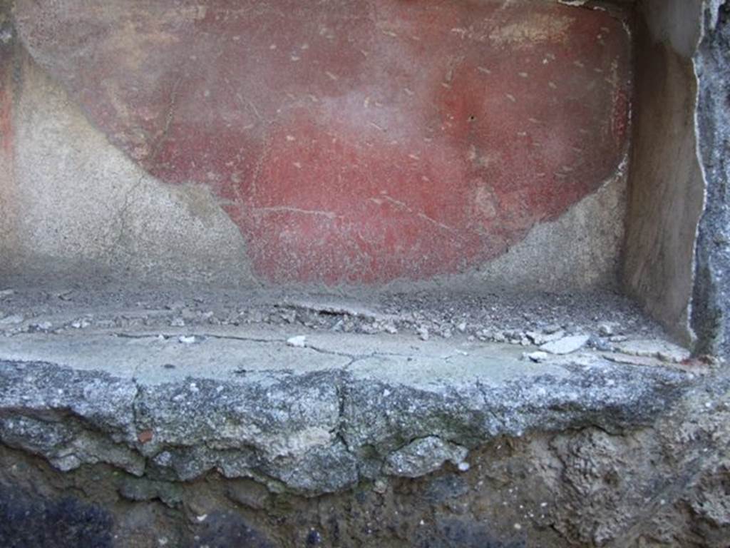 IX.9.c Pompeii. March 2009. North wall of north-west corner of portico.  
According to Boyce –
in the pillar that separates two doorways on the north side of the peristyle was a rectangular niche (h.0.30, w.0.28, d.0.20, h. above floor 1.38).
The niche was adorned with a stucco aedicula façade which consisted of two half-columns supporting a pediment.
In the tympanum was a patera upon a bluish background.
Also according to Boyce, a bronze figure of Hygeia seated upon a throne with her feet upon a footstool, was found in a room to the left of the fauces.
On each side of the throne stood a small tree, around which coiled a serpent.
See Boyce G. K., 1937. Corpus of the Lararia of Pompeii. Rome: MAAR 14. (p. 93, no. 467, and Note 4).
Giacobello described it as a pseudo-aedicula lararium. 
See Giacobello, F., 2008. Larari Pompeiani: Iconografia e culto dei Lari in ambito domestico. Milano: LED Edizioni, (p.287 no.V85)

  