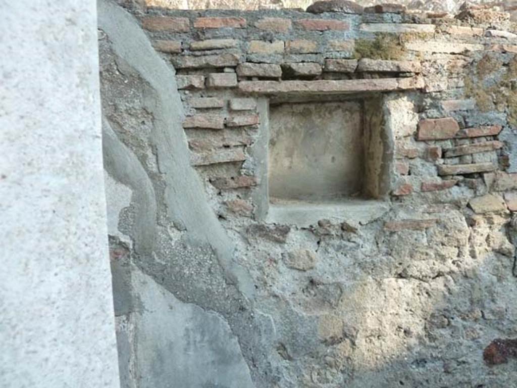 HGW25 Pompeii. September 2015. Lararium in south wall, with remains of a painted Fortuna with rudder and cornucopia. 
No 67, 68 and 69 on the La Vega plan –
From PAH 1,1, p.272-3, 1st May 1773: (addendum p.129 and 159 – original at end of photos): (La Vega: 67, 68, 69). 
After having worked for many weeks to lift the earth from around the rustic courtyard of the said dwelling, we have entirely freed two rooms near to the said courtyard. Although, these have very ordinary floors and everything poorly arranged, they are not worth mentioning having some ordinary paintings decorated with panels.
These (rooms) would have been used by the servants of the owners, because of the worktools found used to cultivate the soil, and for cooking, and for the large quantity of ordinary vessels that there were, that is to say water-jugs, pots of many sorts well smoked, and caraffes, many of which were found broken.
The entire things found in the indicated rooms were - (see page 273 for the list of the finds, Bronze, Glass, Terracotta)
In the entrance of the courtyard, there was a small room with the usual; and in a small niche of the same room, there was a painted Fortuna, as one could see by the rudder and the horn of plenty. Above this room, there was a partition with burnt straw, of which…. (della quale si son fatti prendere alcuni massi)

