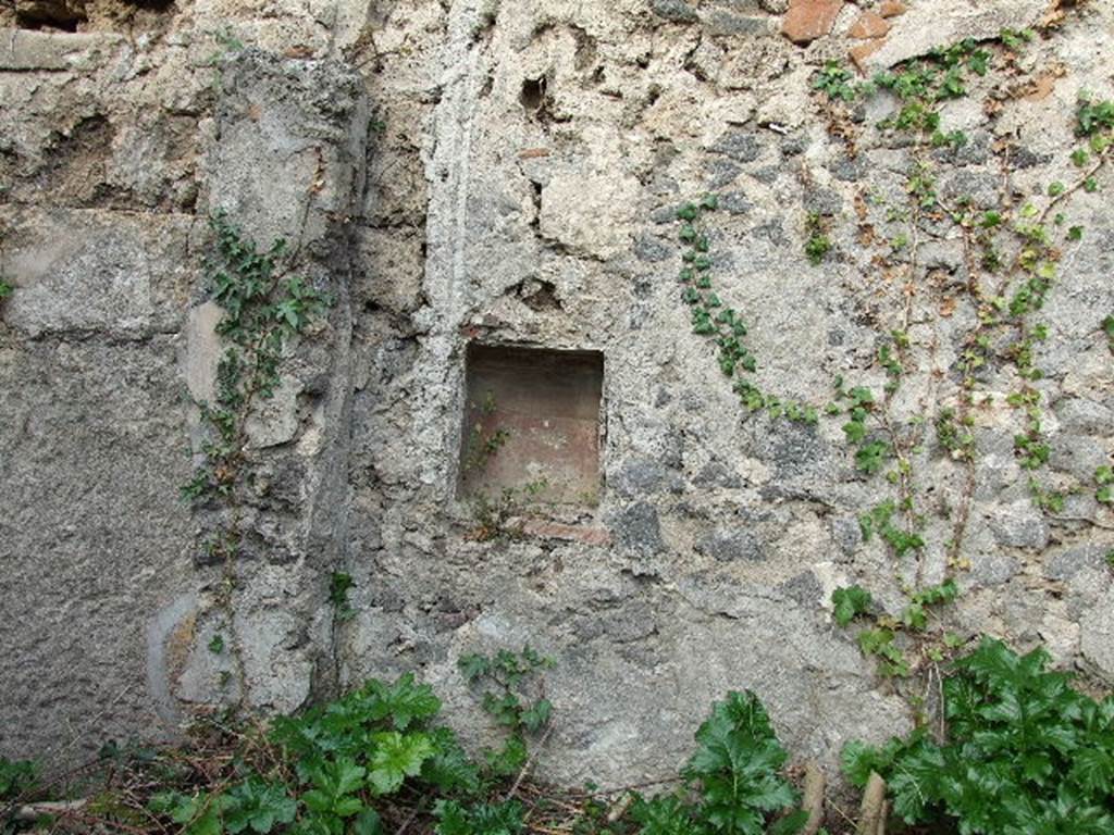 I.2.10 Pompeii. December 2006. On the left, the north-east corner of the triclinium (with remains of east wall with window just visible). In the centre, and on right, north wall of garden area with niche and remains of roughly executed aedicula façade. The niche would have been situated above the north couch of the biclinium.

