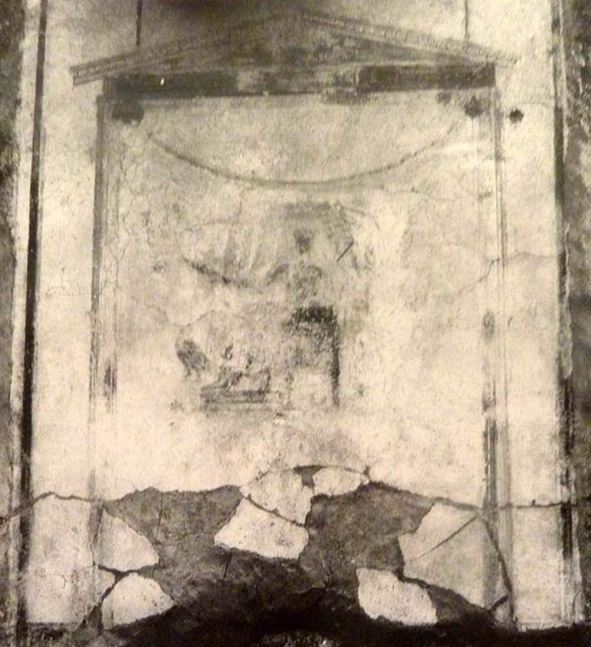 V.2.15 Pompeii. Old undated photograph. North wall of peristyle garden 11c. Remains of central painting in lararium.
Giove (Jupiter) sits on a throne, his lower body covered with a green robe. 
The sceptre is in the left hand, leaning on the arm of the throne. 
The lightning bolt is in his outstretched right hand and the eagle at his feet. 
See Notizie degli Scavi di Antichità, 1894, p. 439.
