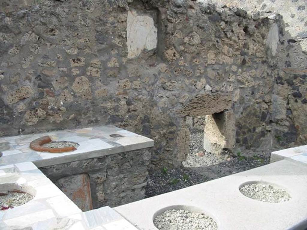 VI.2.1 Pompeii. December 2018. 
Detail of niche in north wall of bar-room. Photo courtesy of Aude Durand.
According to Boyce- 
the large rectangular niche (h.0.65, w.0.50, d.0.18, height above the floor 1.45) had its inside walls painted green.
Fiorelli referred to it as “la nicchia dei Penati”
See Boyce G. K., 1937. Corpus of the Lararia of Pompeii. Rome: MAAR 14. (p44, No.138)

