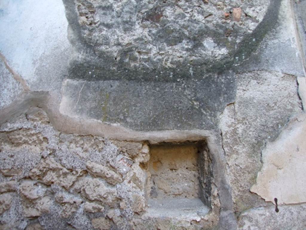 VII.2.14 Pompeii. March 2009. West wall of garden room. Square niche.
According to Boyce, the walls of this small garden were painted with garden subjects, trees, birds and fountain. Later a lararium painting was superimposed on part of it.  In the west wall was set a rectangular niche.
Underneath it and to its right, a masonry altar was built into the corner and covered with yellowish stucco painted as imitation marble.
See Boyce G. K., 1937. Corpus of the Lararia of Pompeii. Rome: MAAR 14.  (p.61-2, 249)
