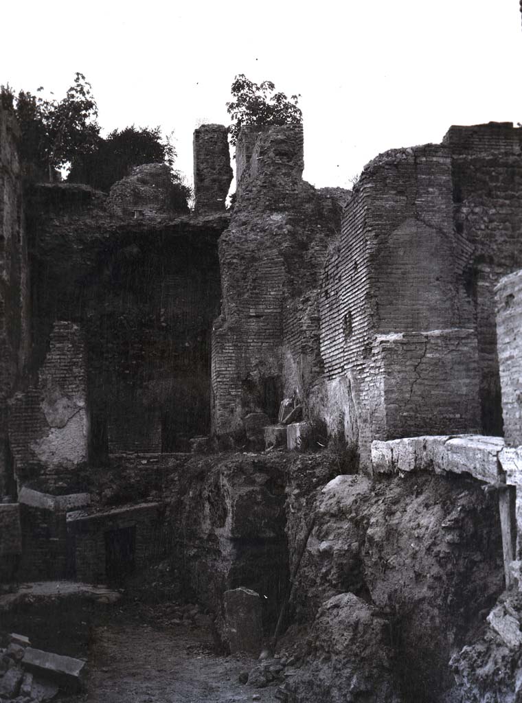 PL.1. Pompeii. Photo by Esther Boise Van Deman (c) American Academy in Rome. VD_Archive_Ph_241.
Description given as Pompeii, Oven, and photo from between 1900-1930.
It does not seem to correspond to any of the ovens in bakeries, the walls look too big to be from a house.
Perhaps the photo is from a Villa, now reburied.
Ostia has been suggested to us, but we wrote to them and they answered that it was not from there.
Espen B Andersson has suggested -
“This photo seems to show the entrance to the hypocaust in a Baths building, possibly in Rome.
So much was lost in Rome in the 19th and early 20th century, for instance when they had to have railroads into the city centre, all that is behind Stazione Termini today”.
Can anyone add anything further as to the identity of this intriguing photograph, as we would love to accurately locate it.

