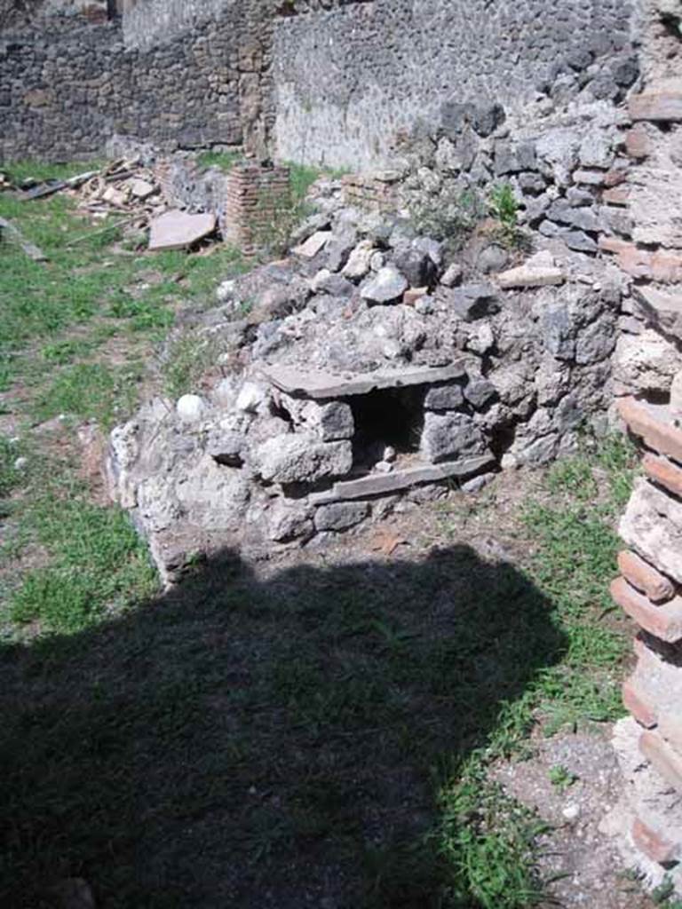 I.1.3 Pompeii. September 2010. Looking north across yard area from doorway to kitchen, with remains of the oven. Photo courtesy of Drew Baker.
