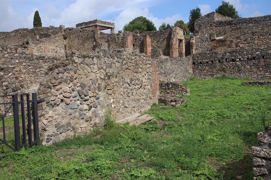 I.1.8 Pompeii. October 2024. 
Doorway leading to I.1.9, on left, with north wall of large entrance room, in centre. Photo courtesy of Klaus Heese.
