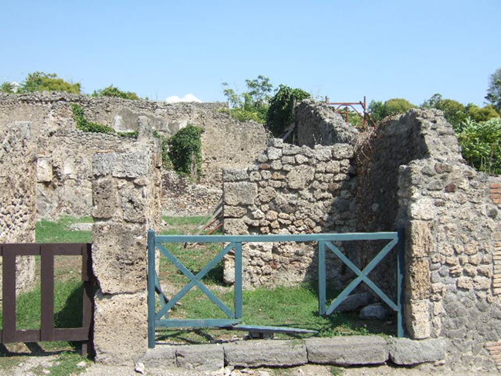 I.2.2 Pompeii. May 2005. 
Looking east into shop room with a rear door into the atrium of the house at I.2.3.          

Warscher described this as  I.2.2 taberna communicante con la casa No.3.
See Warscher T., 1935. Codex Topographicus Pompeianus: Regio I.2. Rome:DAIR.          
                                                                    