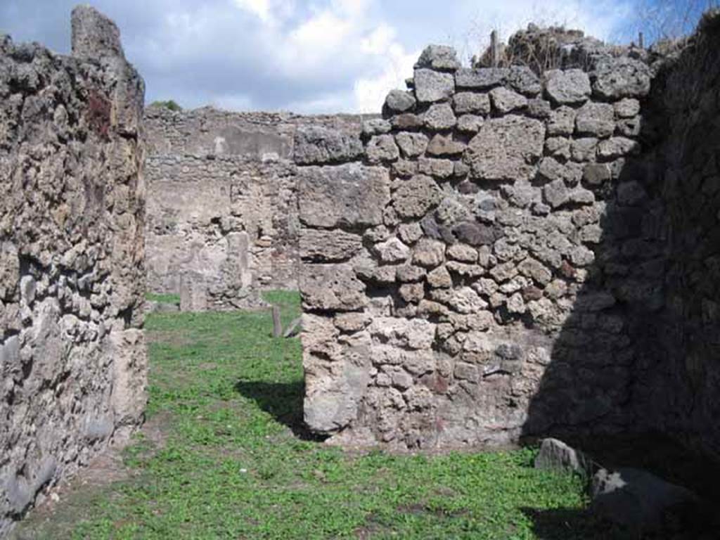 I.2.2 Pompeii. September 2010. Rear (east) wall looking east into atrium of I.2.3. Photo courtesy of Drew Baker.
