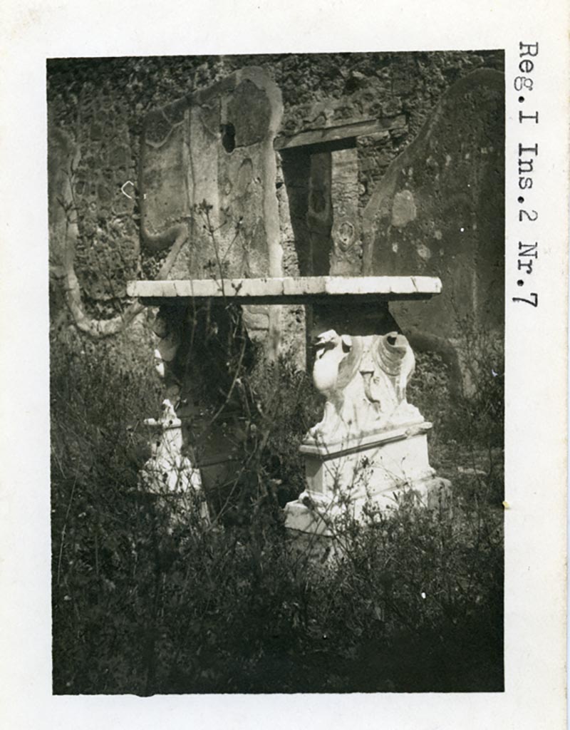 I.2.6 Pompeii but numbered as I.2.7 on photo. Pre-1937-39. 
Looking north-east across atrium towards small doorway into portico of peristyle.
Photo courtesy of American Academy in Rome, Photographic Archive. Warsher collection no. 543.

