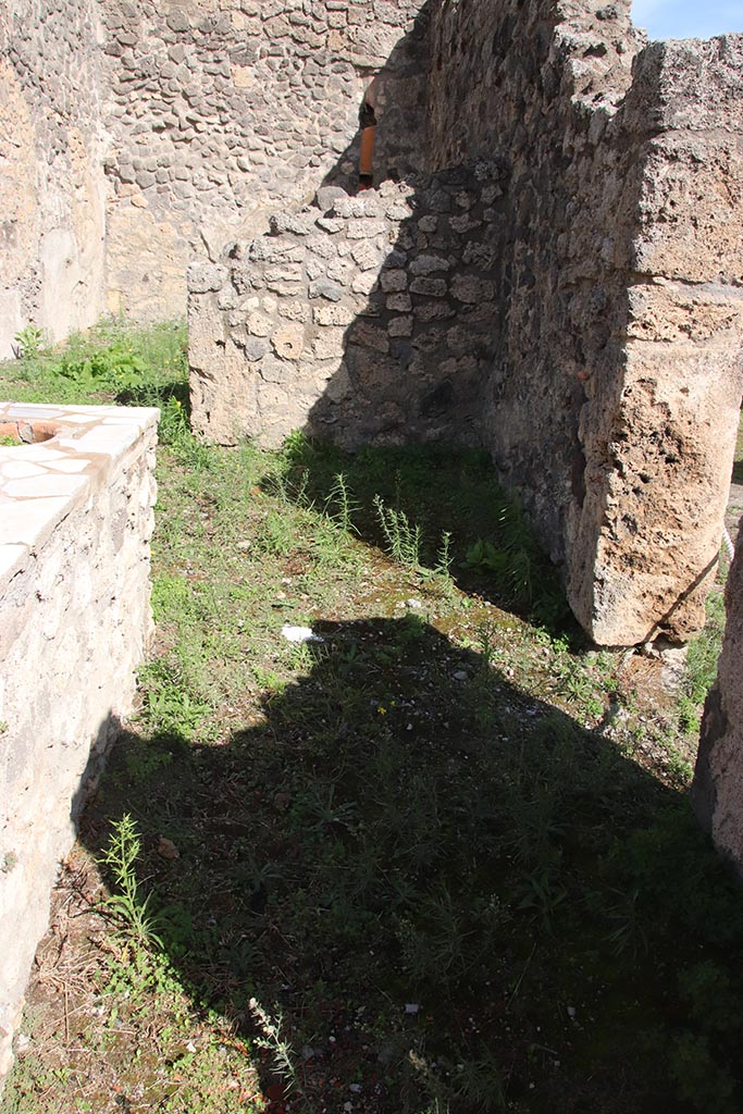 I.2.8 Pompeii. October 2024. 
South-east corner of bar-room, with doorway into I.2.7 in south wall. Photo courtesy of Klaus Heese.
