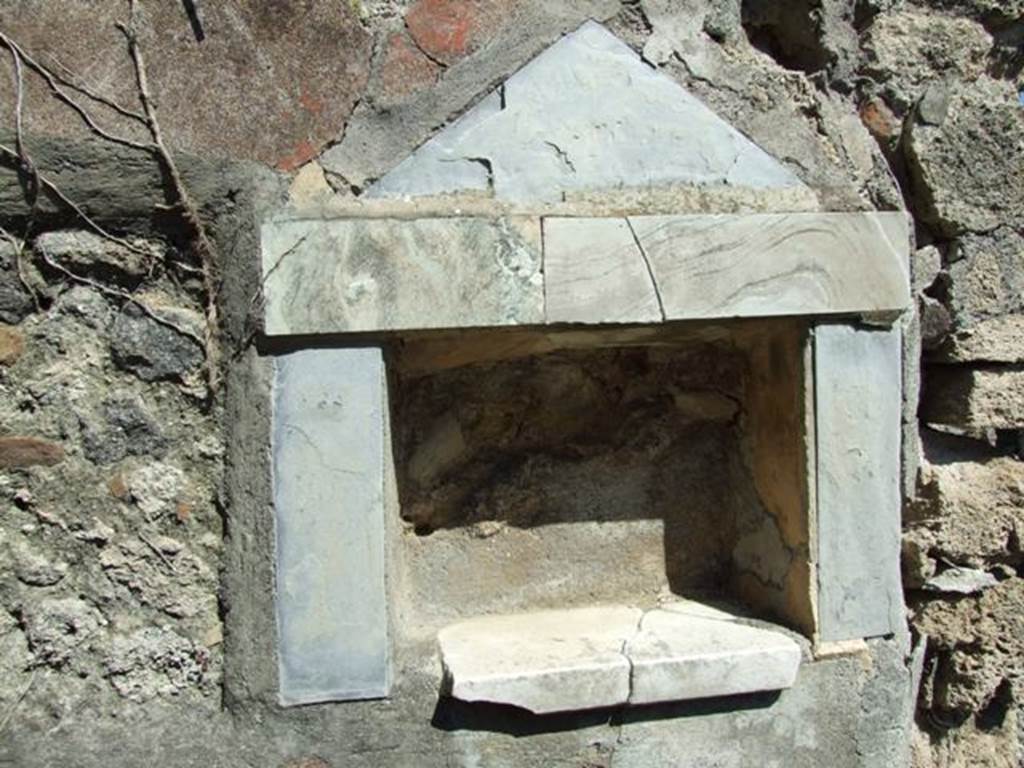 I.2.17 Pompeii. March 2009. Lararium niche of coloured marble, in east wall of fauces. According to Boyce, the walls, projecting floor and aedicula faade of this rectangular niche are all of greyish marble. In the floor were three holes for the bases of statuettes. See Boyce G. K., 1937. Corpus of the Lararia of Pompeii. Rome: MAAR 14.  (p.22 no.9, pl.7,2)
