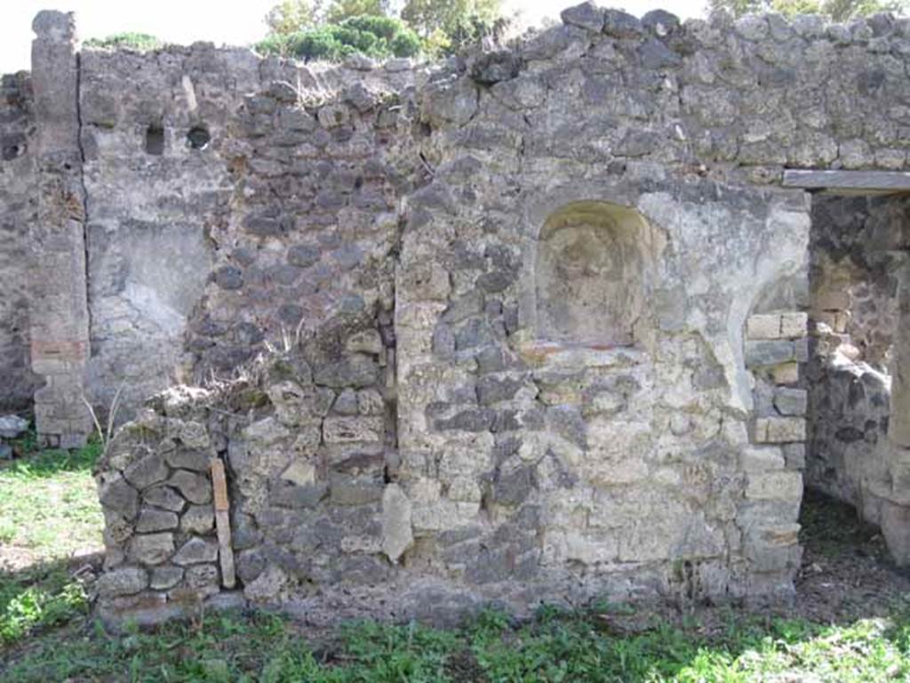 I.2.24 Pompeii. September 2010. East half of south wall of atrium, with niche.  The stairs are behind the wall on the left.  Photo courtesy of Drew Baker.

