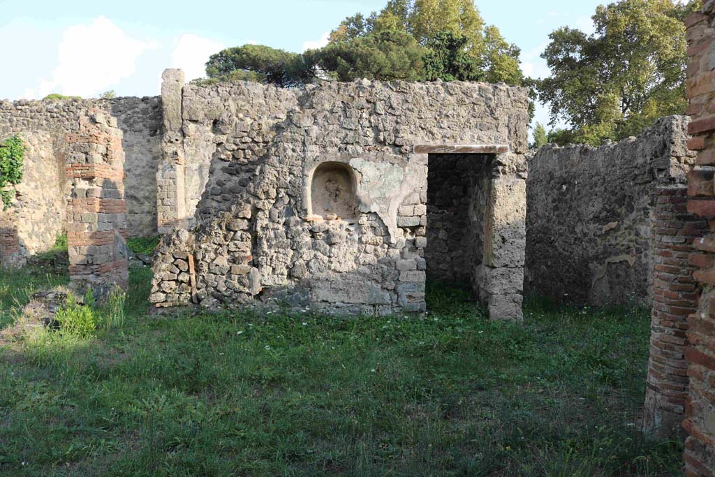 I.2.24 Pompeii. September 2010. East half of south wall of atrium, with niche.  The stairs are behind the wall on the left.  Photo courtesy of Drew Baker.

