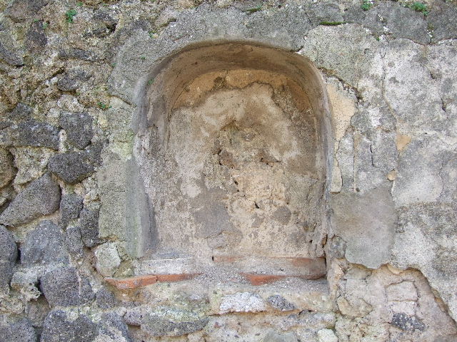 I.2.24 Pompeii.  December 2006.   South wall of Atrium, with Niche for the Penates.  Originally one would have seen a painting of the usual serpents, two Lares, and the Genius sacrificing. At the sides of the niche were two quadrupeds, one of which was perhaps a wolf. Today only the niche remains.  See Pappalardo, U., 2001. La Descrizione di Pompei per Giuseppe Fiorelli (1875). Napoli: Massa Editore. p.37

