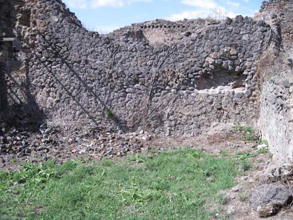 I.2.30 Pompeii. September 2010. Looking north from entrance doorway, with remains of wall in right, corner. Photo courtesy of Drew Baker.
According to CTP, the walls of the latrine near the posticum at I.2.30 were totally destroyed in the 1943 bombing. See Van der Poel, H. B., 1986. Corpus Topographicum Pompeianum, Part IIIA. Austin: University of Texas. (p.4)
According to Eschebach, the latrine may have been under stairs to upper floor? See Eschebach, L., 1993. Gebäudeverzeichnis und Stadtplan der antiken Stadt Pompeji. Köln: Böhlau.(p.14)
According to Fiorelli, this vast room contained the well, a tub for washing the kitchen utensils, and a toilet near to the exit. See Pappalardo, U., 2001. La Descrizione di Pompei per Giuseppe Fiorelli (1875). Napoli: Massa Editore. (p. 34)
