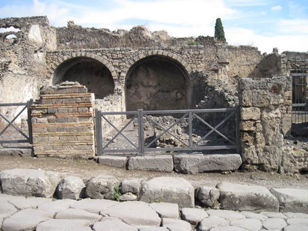 I.3.5 Pompeii. September 2010. Looking east towards entrance doorway from across the Via Stabiana. Photo courtesy of Drew Baker.
According to Warscher, quoting Fiorelli, she wrote –
I.3.5/6 – “Sono due tabernae in relazione tra loro, e perciò appartenute ad un stesso padrone. Entrambe hanno un primo compreso, separate da altro più interno, per un muro in cui è un’ampia finestra, onde ciascuno di essi prendeva luce: entrambe erano coverto da volte, di cui rimane solo la parte più interna. La prima ha nel mezzo un banco o podio di fabbrica, l’altra tiene accanto una cella, che sembra un dormitorio.” 
(translation: "These were two linked workshops joined with each other, and therefore belonged to the same owner.  Both had a front shop-room, separated by other more internal rooms, and by a wall in which was a wide window, so each room one took light from it: both were covered by a vault, but only the innermost part remained.  In the middle of the first (I.3.5) was a masonry table or podium, the other had a room, which seemed to be a dormitory."
See Warscher, T, 1935: Codex Topographicus Pompejanus, Regio I, 3:  Rome, DAIR.  

