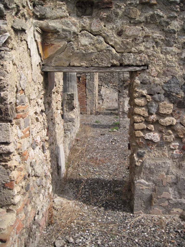 I.3.8b Pompeii. September 2010. Looking east through doorway into exedra and towards south portico. Photo courtesy of Drew Baker.
