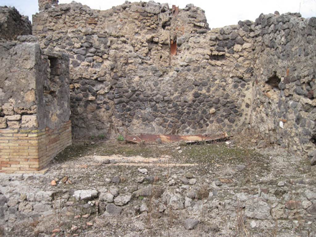 I.3.10 Pompeii. September 2010. Looking north towards north-west corner of ruined room, from first room on the south side. The inspection house for the Sarno canal can be seen on the left. Photo courtesy of Drew Baker. The downpipe of I.3.15, north wall of rear room, can be seen in the upper centre.
