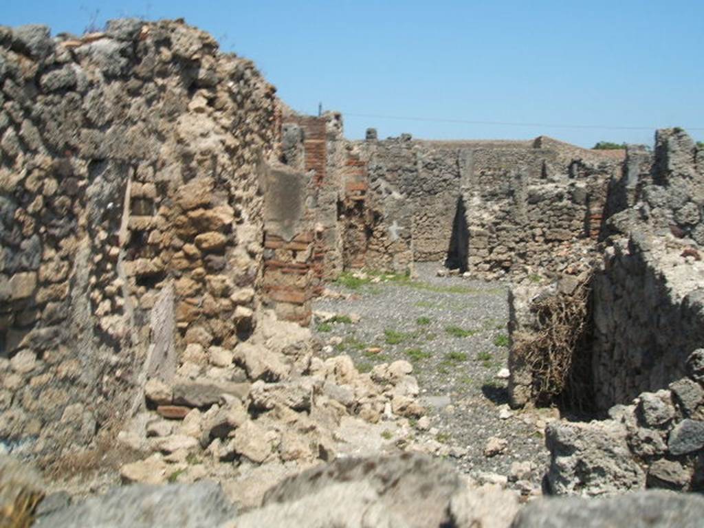 I.3.16 Pompeii. May 2005. Looking east towards I.3.20, from rear of fullonica.