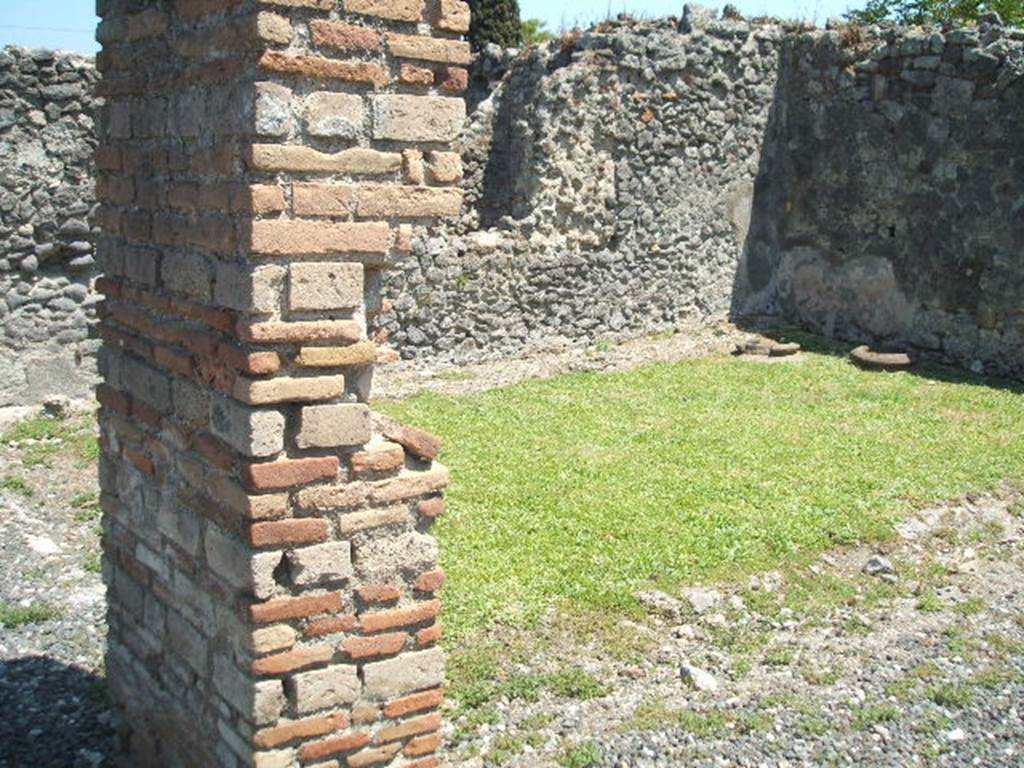 I.3.20 Pompeii. May 2005. Looking south-east towards two dolia buried in the peristyle. Originally there were four dolia.
See Van der Poel, H. B., 1986. Corpus Topographicum Pompeianum, Part IIIA. Austin: University of Texas. (p.6)
According to Boyce, on the right side of the peristyle stood a small altar, coated with stucco. On the yellow background, there were painted festoons and masks. The excavation report called it a lararium.
He gives the reference Bull.Inst., 1869, 242. This is no longer in situ.
See Boyce G. K., 1937. Corpus of the Lararia of Pompeii. Rome: MAAR 14. (p. 24) 
