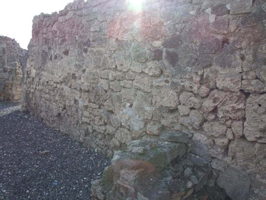 I.3.22 Pompeii. December 2007. West wall.  At the front, on the right, are the remains of the staircase at I.3.21 which led to the upper storey of I.3.22. At the rear, on the left, is a doorway linking to I.3.20.
