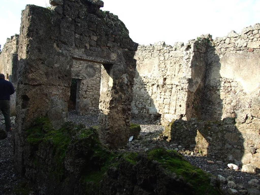 I.3.25 Pompeii. December 2006. Rooms to north of entrance doorway. In the centre of the photo, the north wall of the atrium can be seen through the doorway of the room.
