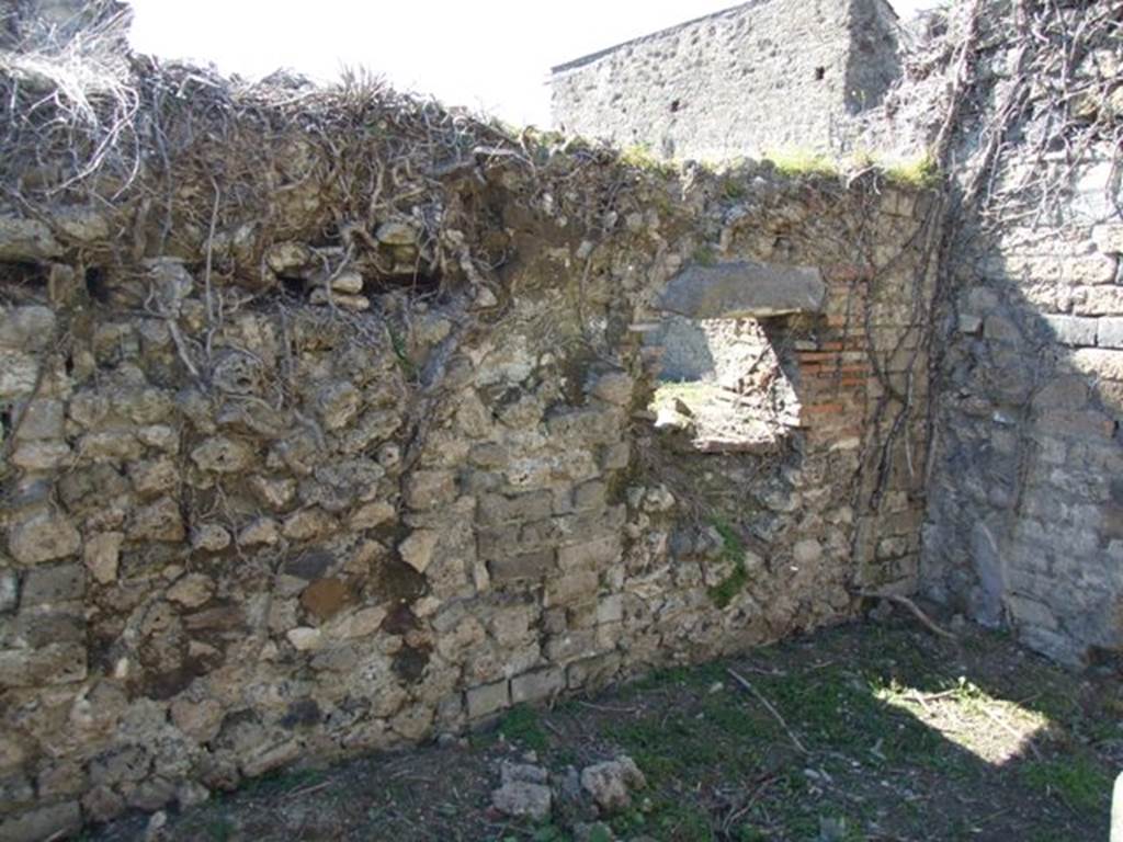 I.3.27 Pompeii. March 2009. West wall, with hatch to oven in room on the east side of the oven.  