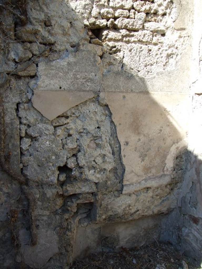 I.3.27 Pompeii.  March 2009. Remains of plaster on north wall of small room, and recess in north-east corner.