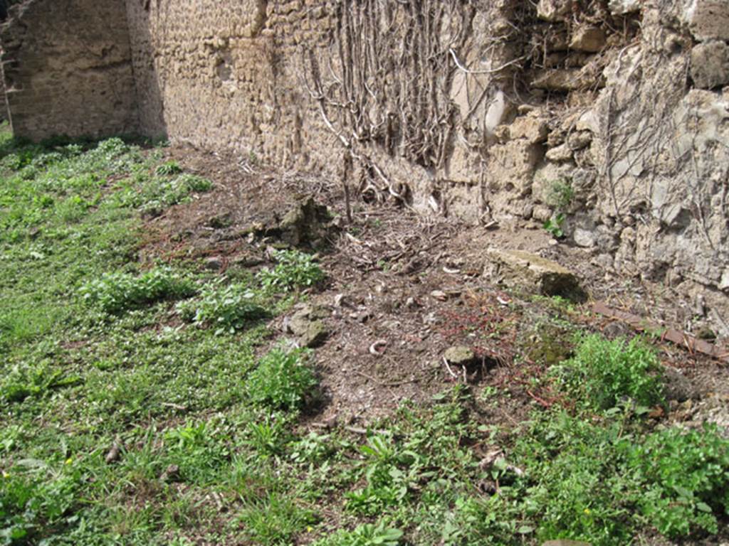 I.3.27 Pompeii. September 2010. 
Looking towards remains of circular feature (base of millstone) at west end of north wall of bakery room. 
Originally there would have been four millstones. Photo courtesy of Drew Baker.

