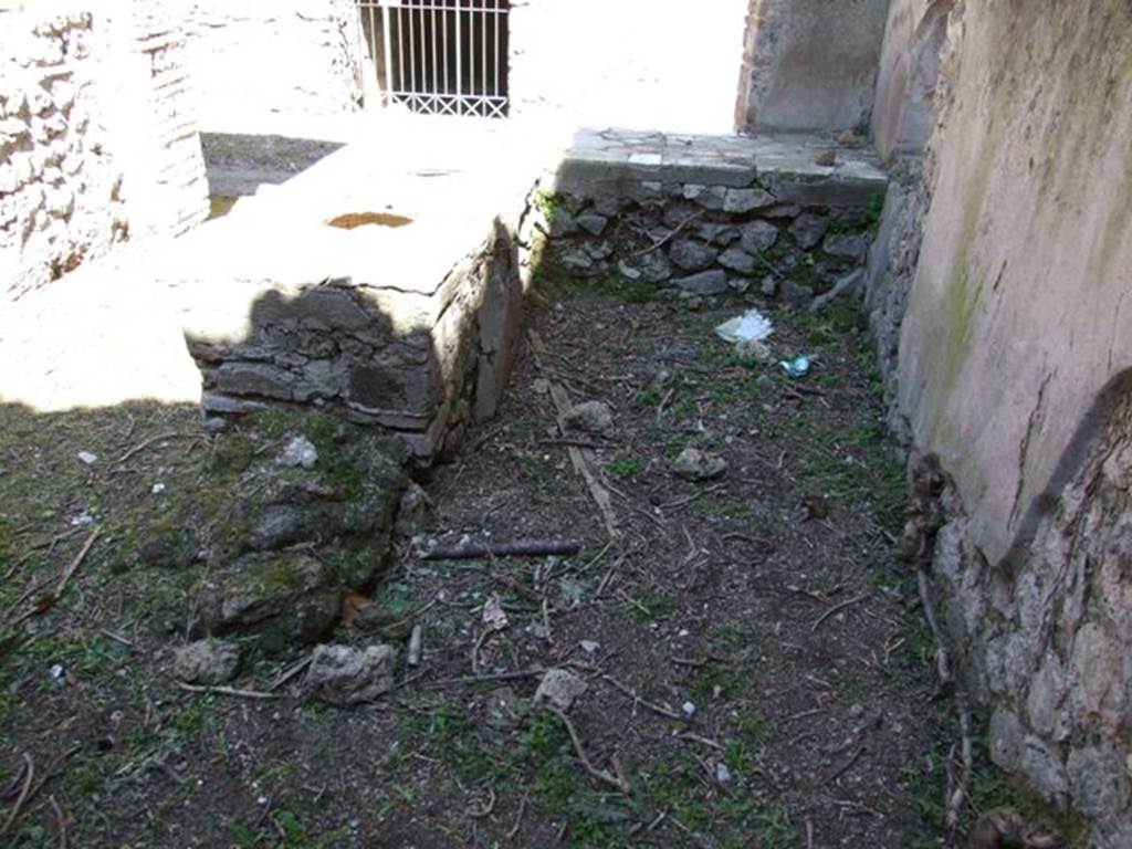 I.3.28 Pompeii. March 2009. Looking east across counter to Vicolo Citarista. The remains of a hearth can also be seen on the end of the counter.
