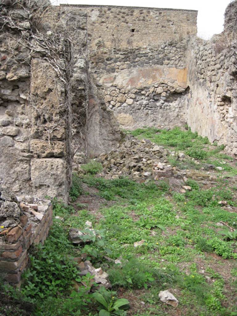 I.3.30 Pompeii. September 2010. Looking north from entrance corridor towards peristyle area. Photo courtesy of Drew Baker.
According to Jashemski, the peristyle garden of this small house without an atrium (excavated 1872) was to the right of the north end of the entrance passageway. The garden was enclosed on the west, north, and on part of the south sides by a portico supported by columns joined by a low wall.  See Jashemski, W. F., 1993. The Gardens of Pompeii, Volume II: Appendices. New York: Caratzas. (p.28)
