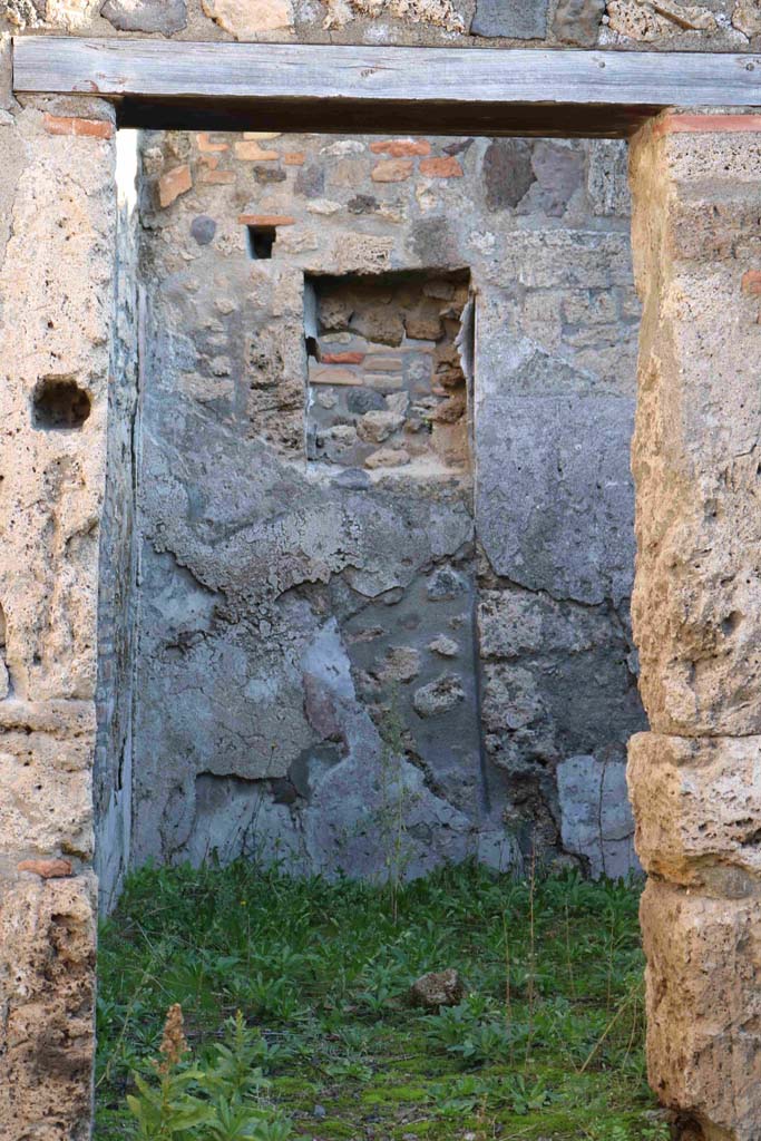 I.4.4 Pompeii. December 2018. 
Looking east through doorway to rear room, with niche in east wall. Photo courtesy of Aude Durand.
