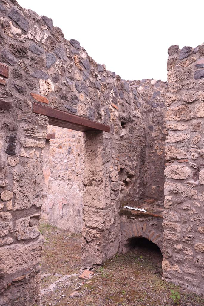 I.4.4 Pompeii. October 2019. West wall with doorway into shop-room, and hearth in north-west corner. 
Foto Tobias Busen, ERC Grant 681269 DCOR.
