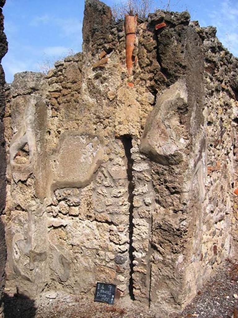 I.4.9 Pompeii. July 2008. Downpipe on north wall of entrance corridor or fauces. Photo courtesy of Barry Hobson.