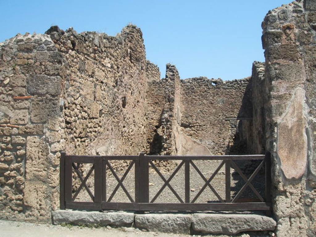 I.4.11 Pompeii. May 2005. Entrance. According to Della Corte, this was a small shop furnished with two rooms for the clients, and with a small garden.  He jokes the shop was modest, but very promising for the clients, as the name of the owner was thought to be Copiosus. This name was shown in the graffiti found to the right of the entrance:
Sittium Magnum a[aed(ilem)] o(ro) v(os) f(aciatis)
Copiosus rogat   (CIL IV 989)
See Della Corte, M., 1965.  Case ed Abitanti di Pompei. Napoli: Fausto Fiorentino. (p. 263)

On the pilaster on the left side, between I.4.12 and I.4.11, the following painted graffiti were found in May 1853.
Painted in black or red, they were:

A(ulum) Postumium aed(ilem)
scr(ibsit) Infantio infra
scribente Parente II
rog(at)  (CIL IV 984)

Paquium Proculum d(uumvirum) i(ure) d(icundo) d(ignum) r(ei) p(ublicae)  (CIL IV 985)

N(umerium) Popidium [Rufu]m aed(ilem)  (CIL IV 986)

Alb[ucium]  (CIL IV 987)

Postumium  (CIL IV 987a)

Ma[...]  
Ceium  (CIL IV 988)

See Pagano, M. and Prisciandaro, R., 2006. Studio sulle provenienze degli oggetti rinvenuti negli scavi borbonici del regno di Napoli. Naples : Nicola Longobardi. (p.168) 
