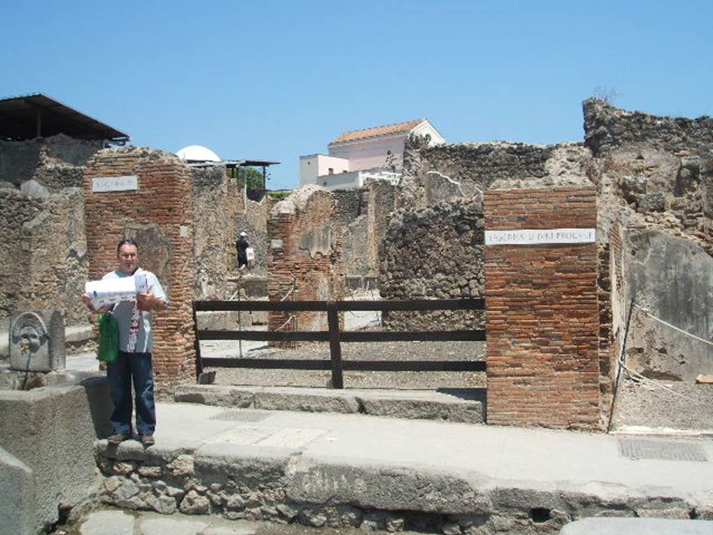 I.4.15 Pompeii. September 2005.  Looking north-east across shop, towards other entrance on Via dellAbbondanza.  According to Fiorelli, on 9th December 1853, a bronze lamp was found with the name of the patron of the shop incised into an attached tablet:
DIVNI
PROQVLI
See Pappalardo, U., 2001. La Descrizione di Pompei per Giuseppe Fiorelli (1875). Napoli: Massa Editore. (p43)
The lamp is described as being of bronze with two wicks, incised with the name -
D(ecimi)  Iuni
Proquli  (CIL X 8071)
The lamp is now in the Naples Museum, inventory number 72166.
See Pagano, and Prisciandaro, R., 2006. Studio sulle provenienze degli oggetti rinvenuti negli scavi borbonici del regno di Napoli. Naples : Nicola Longobardi. (p.171) 
